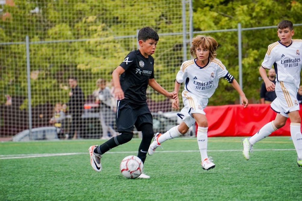 A Forms Madrid player on the ball against Real Madrid