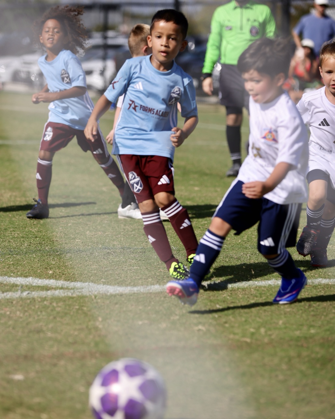 A Forms Academy player driving through traffic with the ball